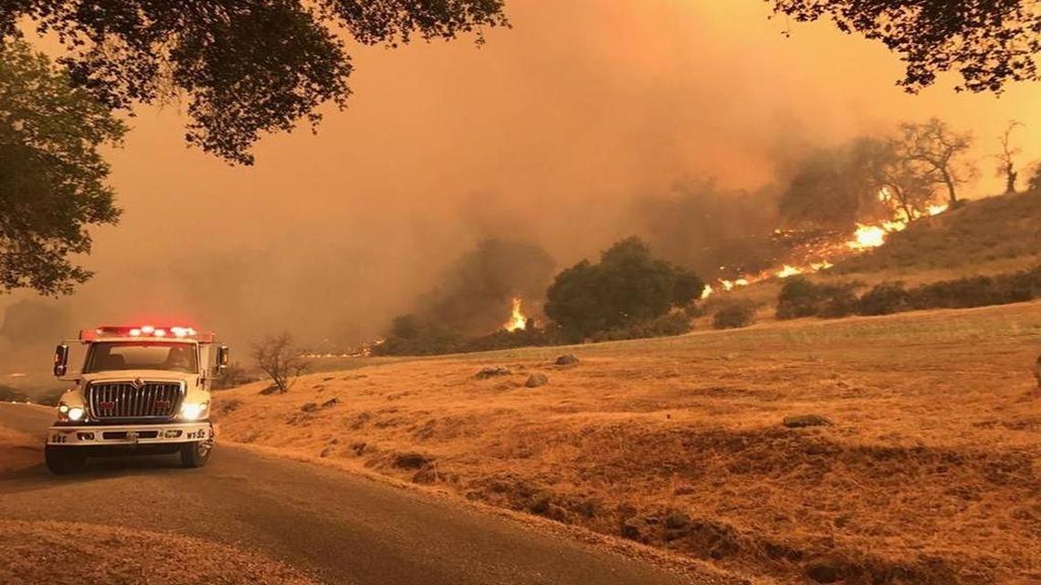 Flames from the Whittier Fire near Lake Cachuma burn toward a ranch on the south side of Highway 154 on Saturday, July 8, 2017.