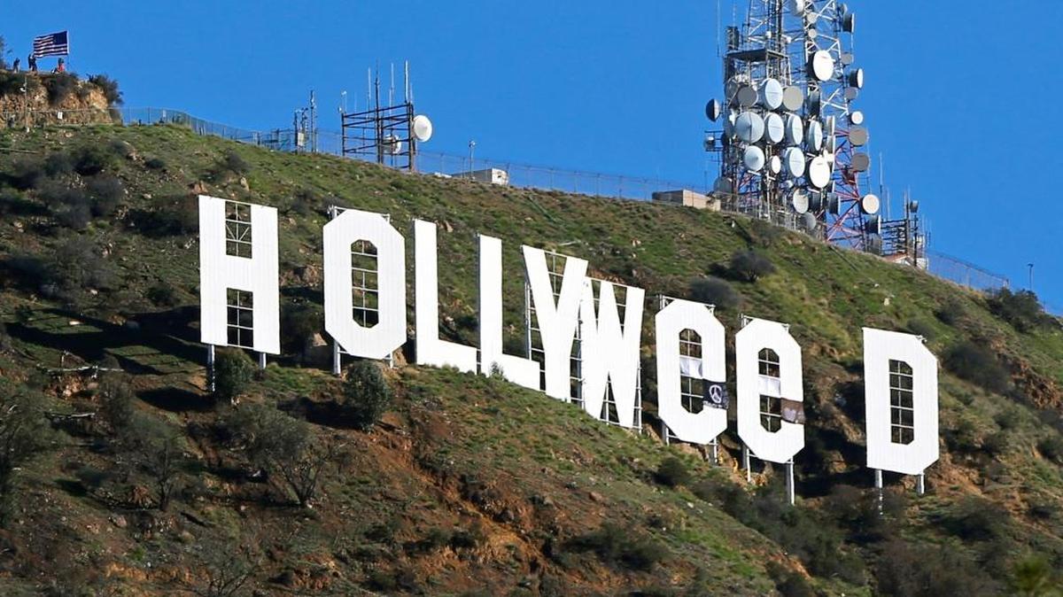 In this Jan. 1, 2017, file photo, the famed Hollywood sign is seen altered to read “HOLLYWeeD,” in Los Angeles.