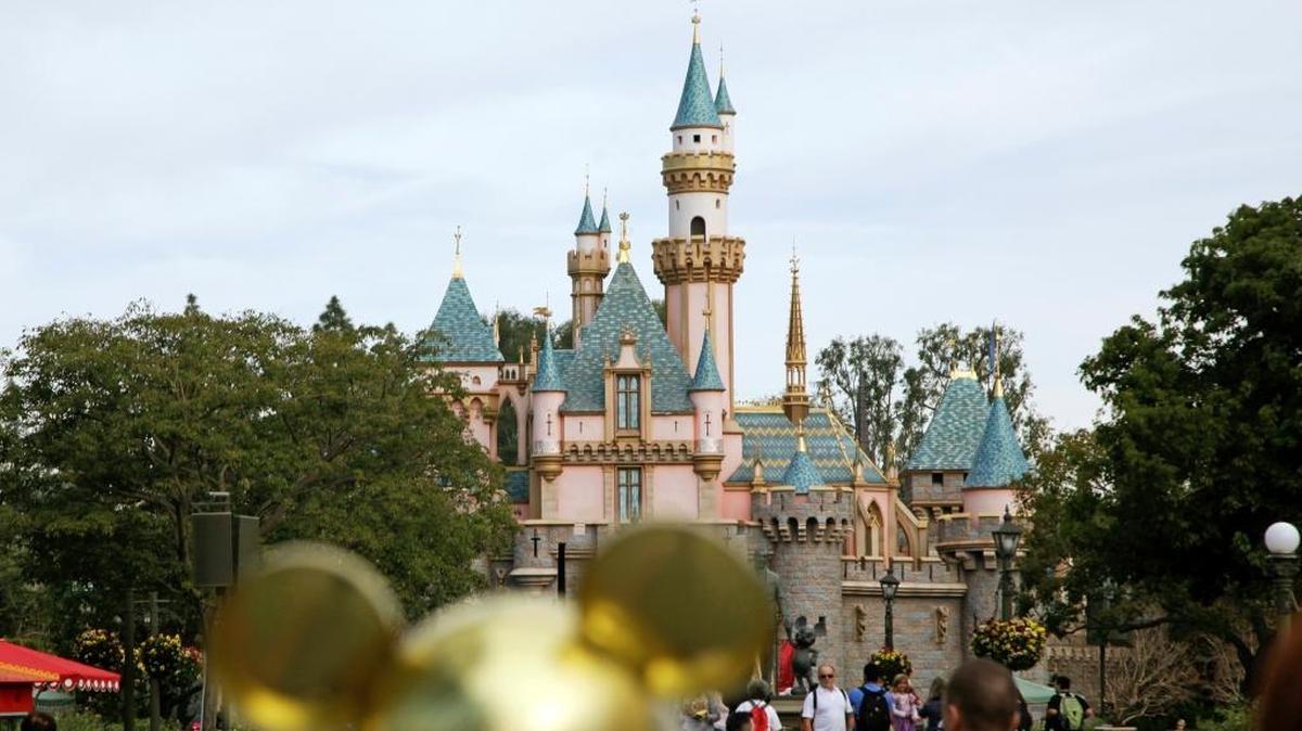 Visitors walk toward Sleeping Beauty’s Castle at Disneyland in Anaheim, on Jan. 22, 2015.