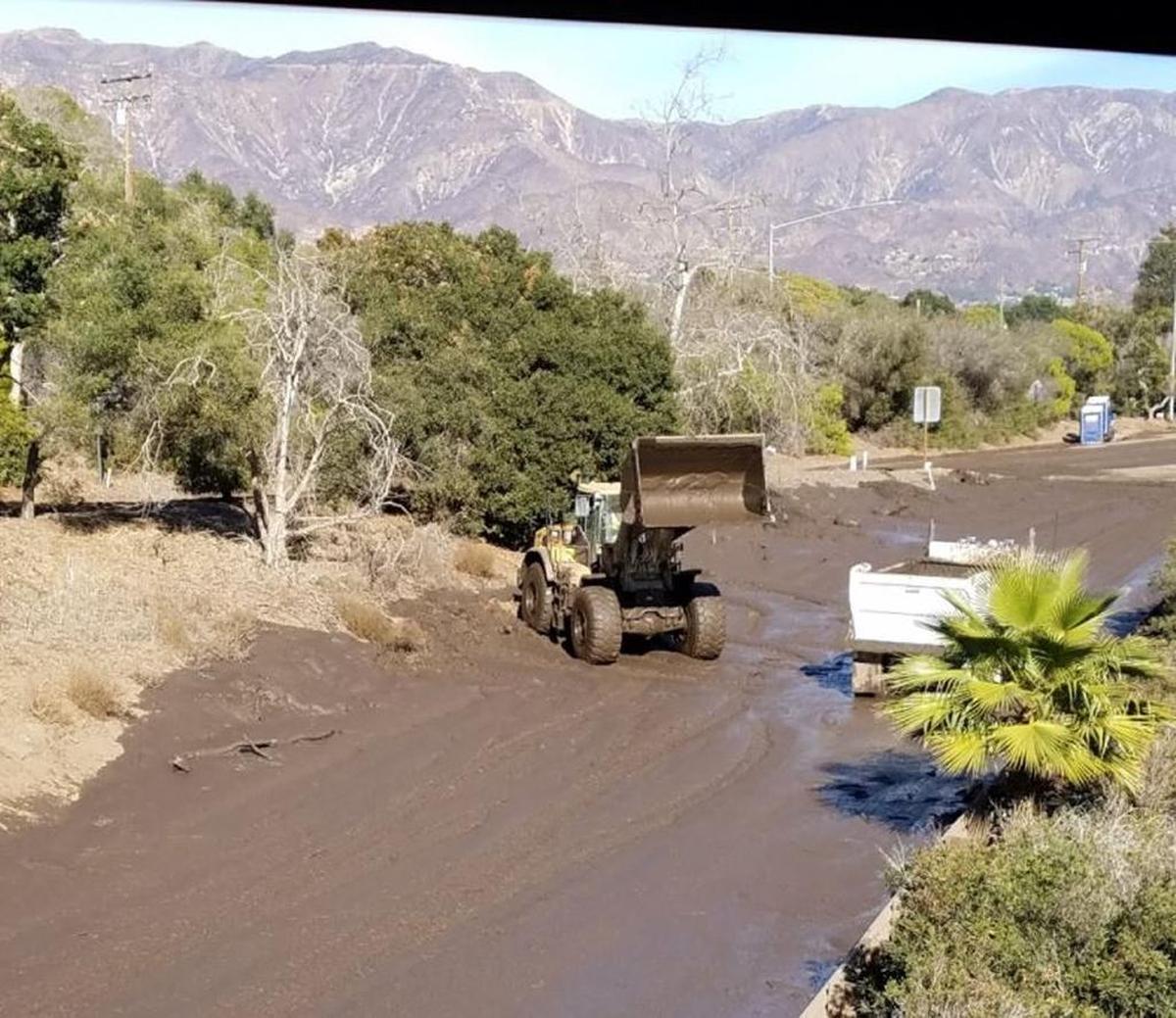 Caltrans crews work to get water off Highway 101 on Sunday, January 14, 2018.
