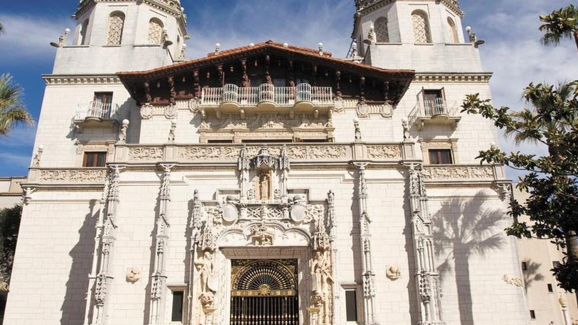 A tour group gathers in the shade in the plaza in front of Casa Grande at Hearst Castle. Beginning Tuesday, anyone wishing to reserve a Hearst Castle tour online will need to use a new website.