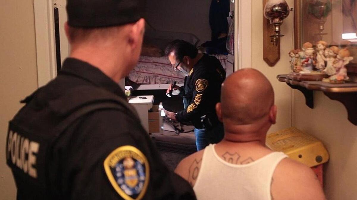 Parole officers do a compliance check on a sex offender in National City, Calif., in 2013.