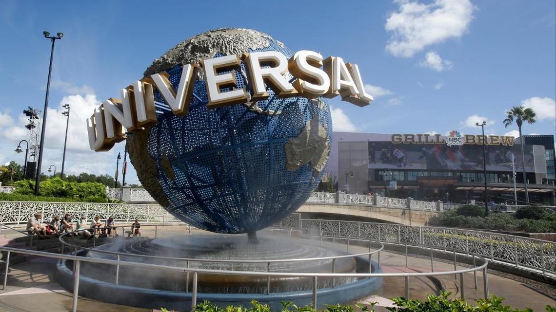 In this Thursday, Oct. 22, 2015, file photo, park guests relax at Universal Studios City Walk in Orlando, Fla. Both the Universal Orlando Resort and Universal Studios Hollywood are increasing their daily ticket prices.