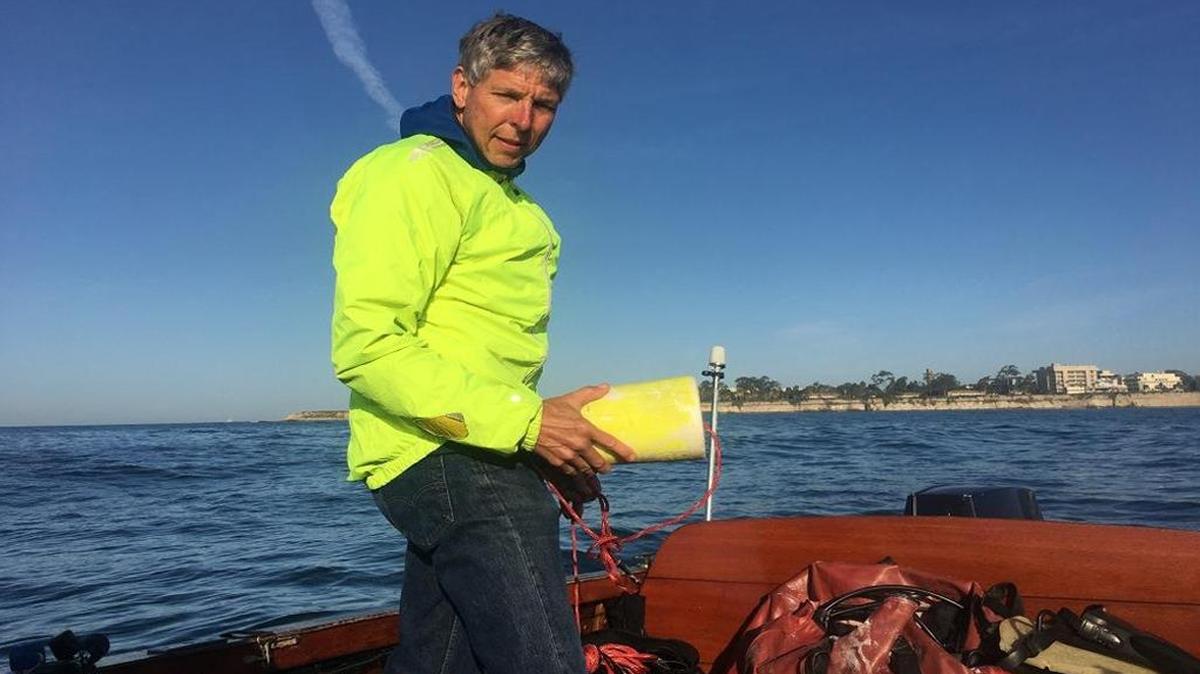 Seattle-based engineer Bob Kiel prepares to set buoys before diving into Goleta Bay.