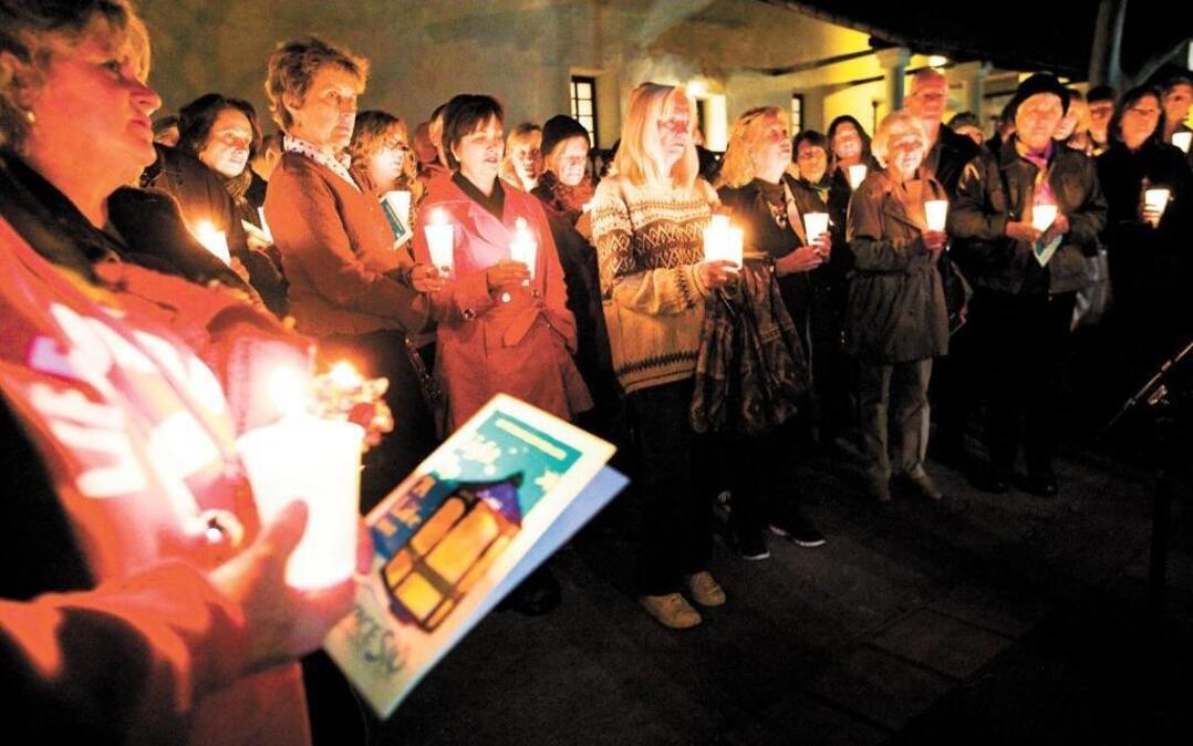 Those who have lost loved ones hold candles in their memory during the Light Up a Life ceremony in 2013 at Mission San Luis Obispo Mission. The holidays can be a challenging time for those mourning the death of a family member or friend, Tribune columnist Linda Lewis Griffith writes.