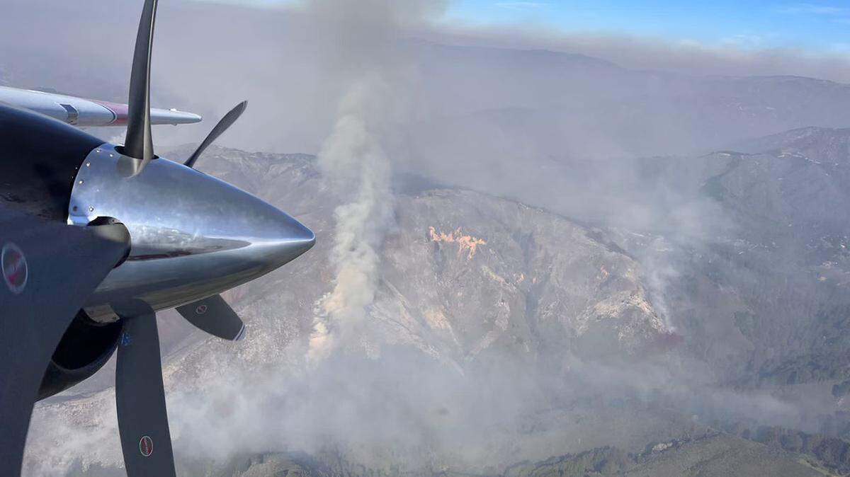 A plane flies over the Colorado Fire in Big Sur.