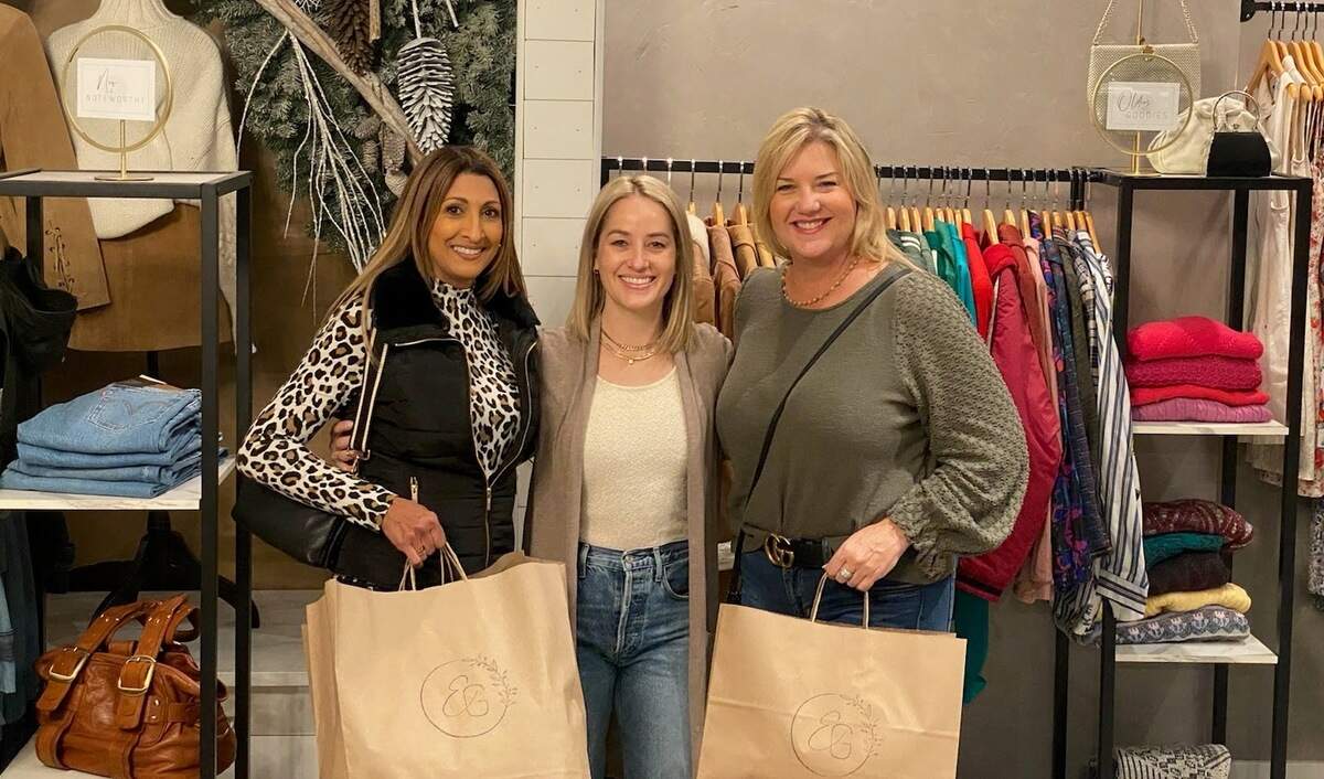Ernest Grace customers Kamal Traxinger (left) and Lisa Chitty (right) pose with store owner Kelsey Miller.
