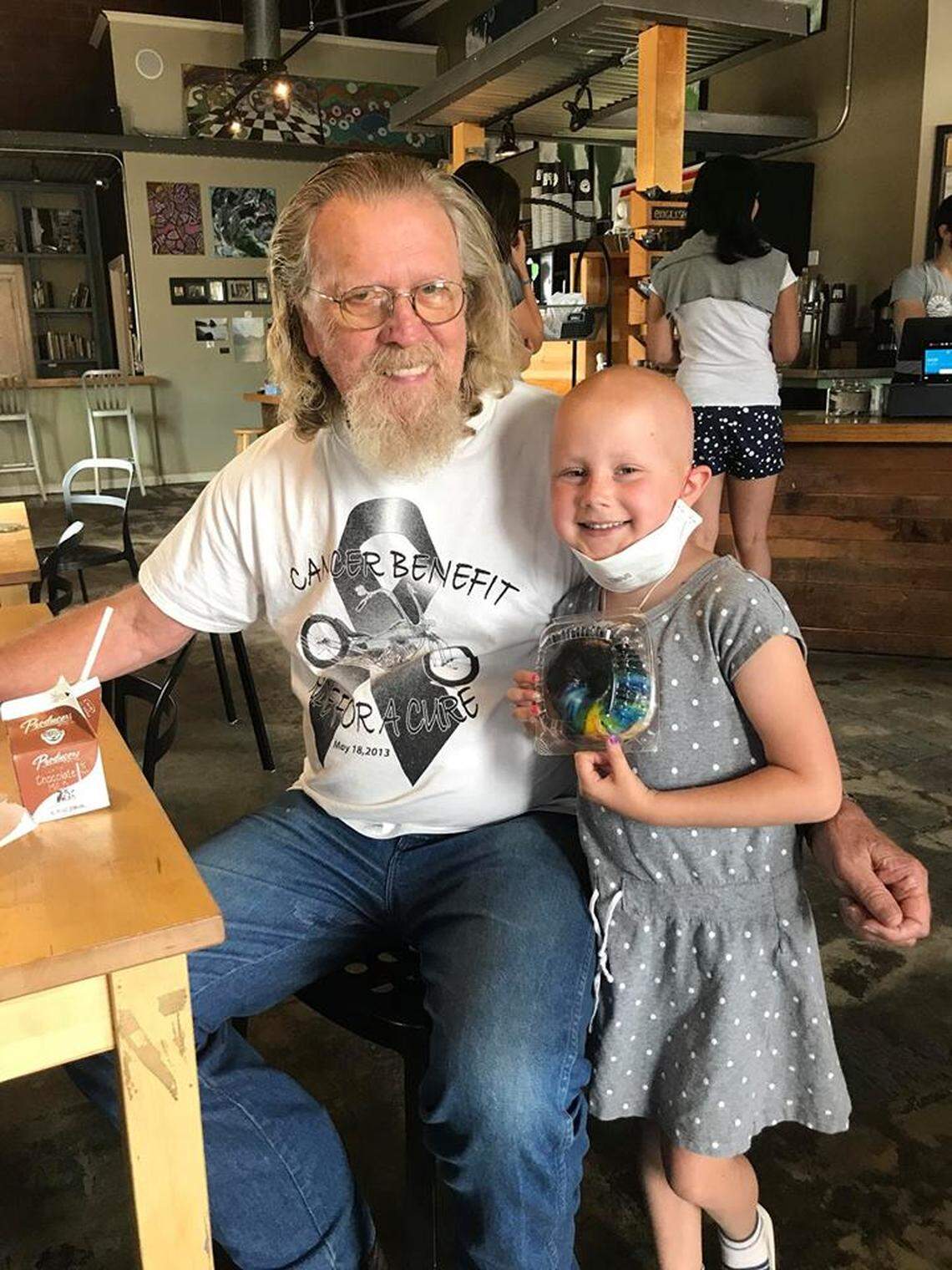 San Luis Obispo resident Claire Noland, 6, was diagnosed with cancer six months ago. Atascadero resident Tom Weatherman, left, bought Claire a doughnut at SLO Donut Co. on July 19 to celebrate optimistic lab results; on Wednesday, July 25, she was told she is cancer free.