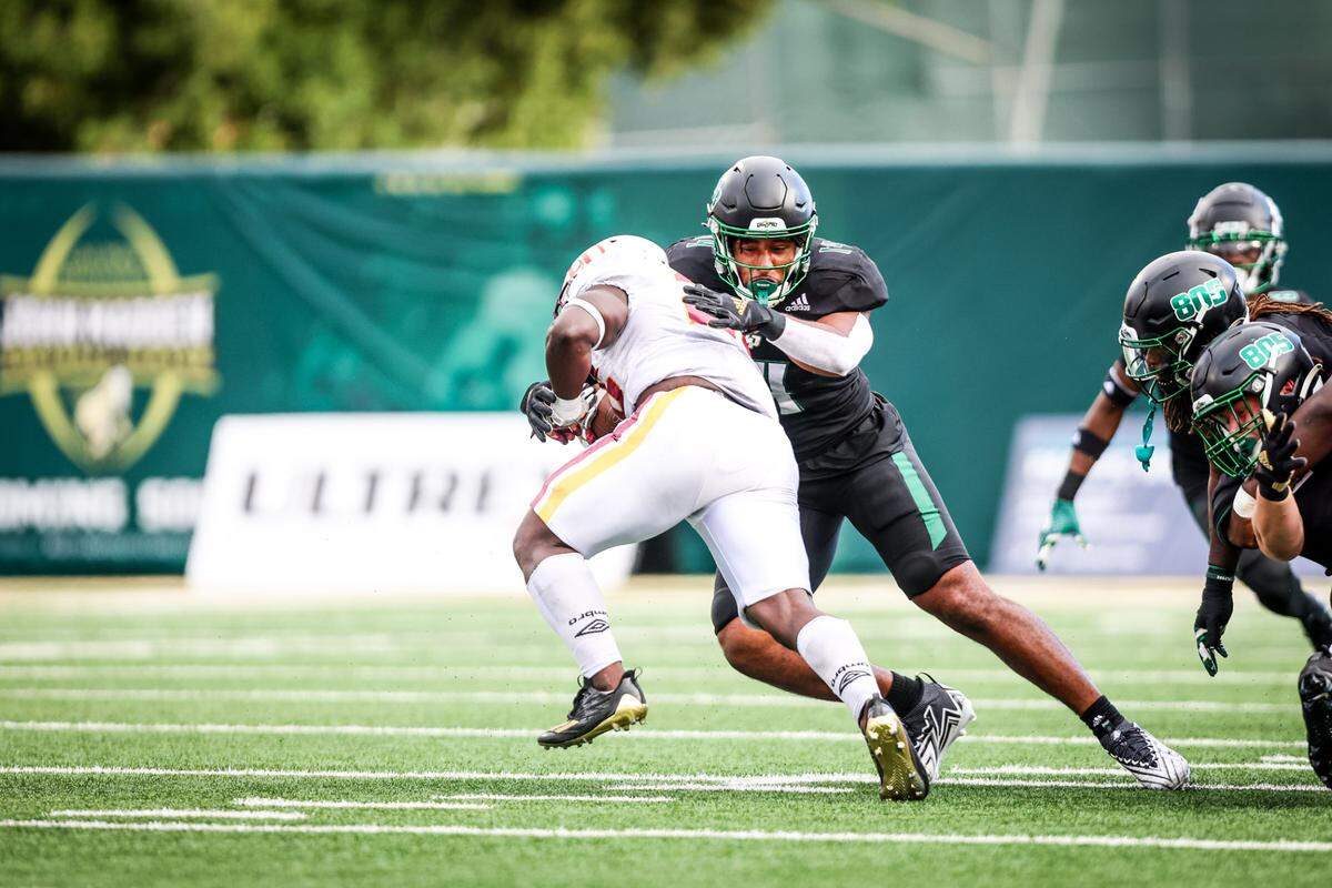 Cal Poly Mustangs defensive lineman Elijah Ponder (14) makes a tackle. The Cal Poly football team beat Lincoln 41-20 at home on Sept. 16, 2023. 