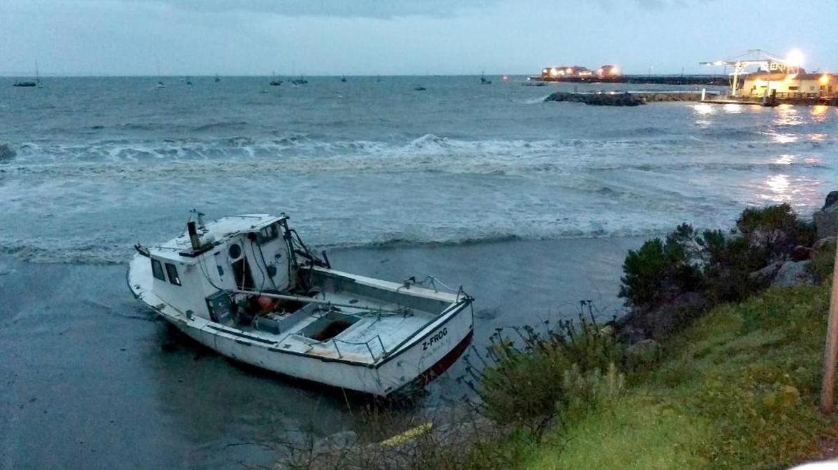 A crab boat washed ashore in Port San Luis on Sunday after high seas broke it loose from its mooring.