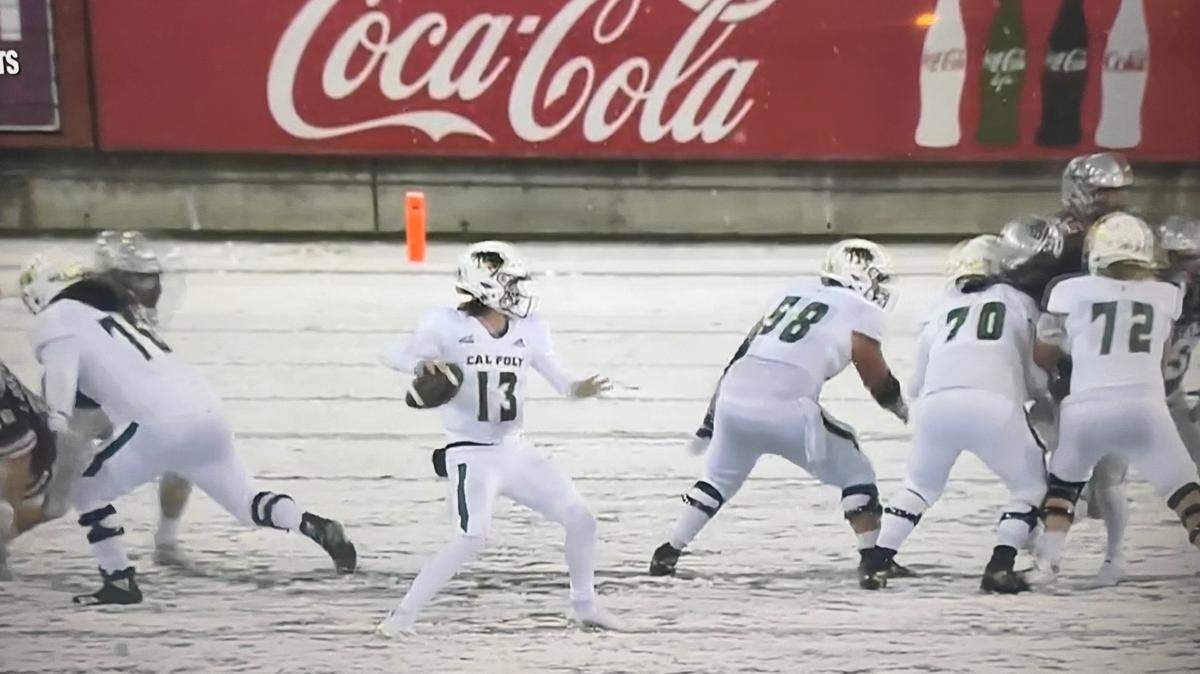 Cal Poly quarterback Spencer Brash looks to pass in the Mustangs 57-0 loss to Montana in a snowy game on Nov. 5, 2022.