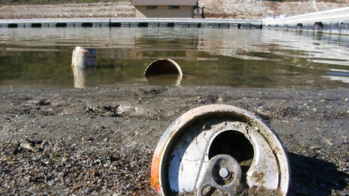 The Lopez Lake shoreline is at a low level, exposing once submerged trash. Drink cans and bottles appear to be the majority. A cleanup day will be held this Saturday from 9 a.m. to noon.