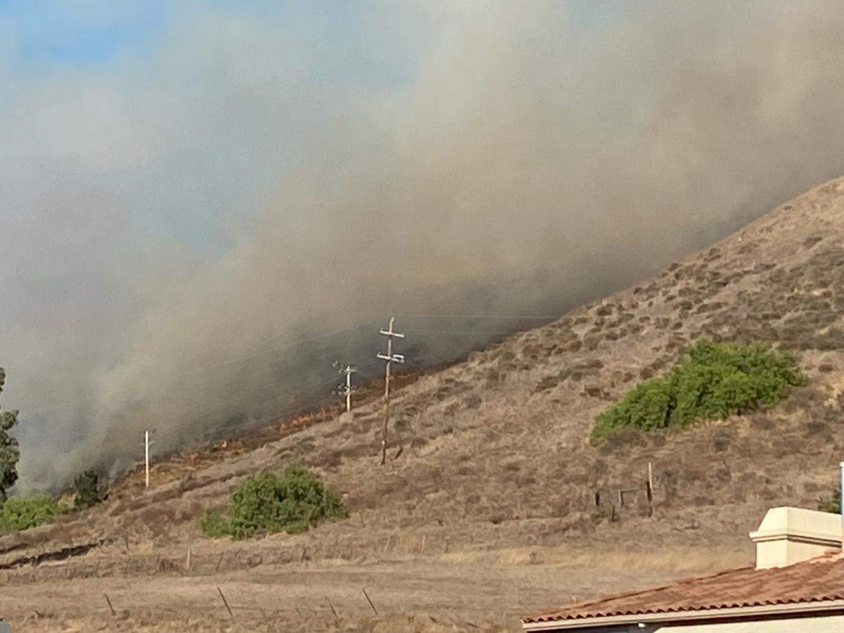 A vegetation fire burns in the hills near Lizzie street in San Luis Obispo on Oct. 30, 2023. The fire apparently started behind the FFA farm at San Luis Obispo High School. Residents nearby were ordered to evacuate.