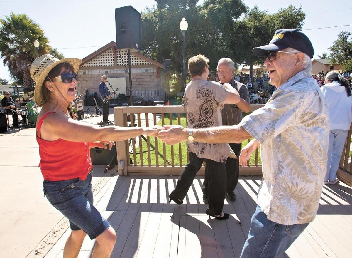 Christine Cooper and Jerry Johns dance to the music of Cadillac Angels during the Sizzlin’ Summer Concert Series and Farmers Market at Ramona Garden Park in Grover Beach.