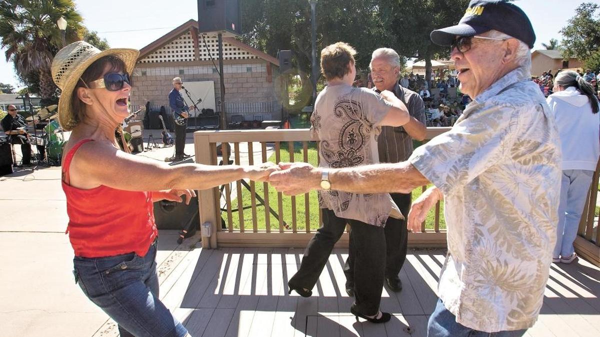 Christine Cooper and Jerry Johns dance to the music of Cadillac Angels during the Sizzlin’ Summer Concert Series and Farmers Market at Ramona Garden Park in Grover Beach.