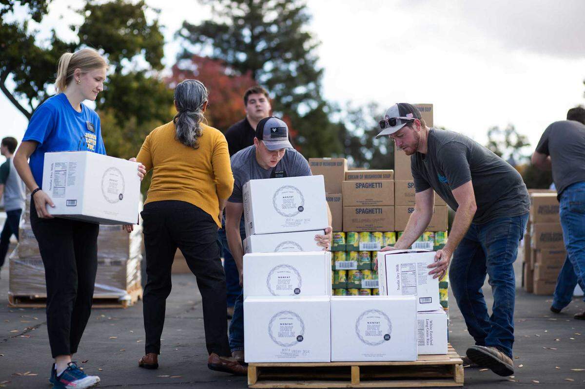 Volunteers sort food donated by The Church of Jesus Christ of Latter-day Saints on Thursday, Nov. 16, 2023, in Paso Robles. A semi-truck carrying 24 pallets of dry goods was unloaded and distributed to several nonprofit organizations.