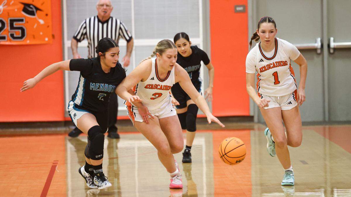 The Greyhounds had to break through a press defense, here Sophia Porter and Whitney Jeckell bring the ball down court. Atascadero girls beat Mendota in a playoff basketball game on Feb. 18, 2025.