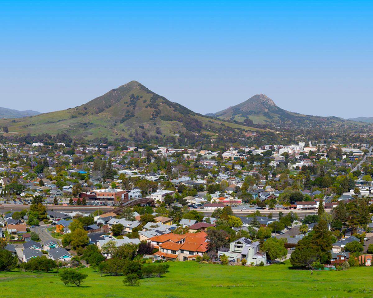 This portion of a panoramic photo taken by Brian Lawler is a close replication of a photo taken from the same location in 1930 by San Luis Obispo photographer Frank Aston. At the time, Terrace Hill was about 60 feet taller than it is now. The top of the hill was removed for freeway gravel. This modern photo was taken from a position approximately 60 feet above the top of the hill using a man-lift.