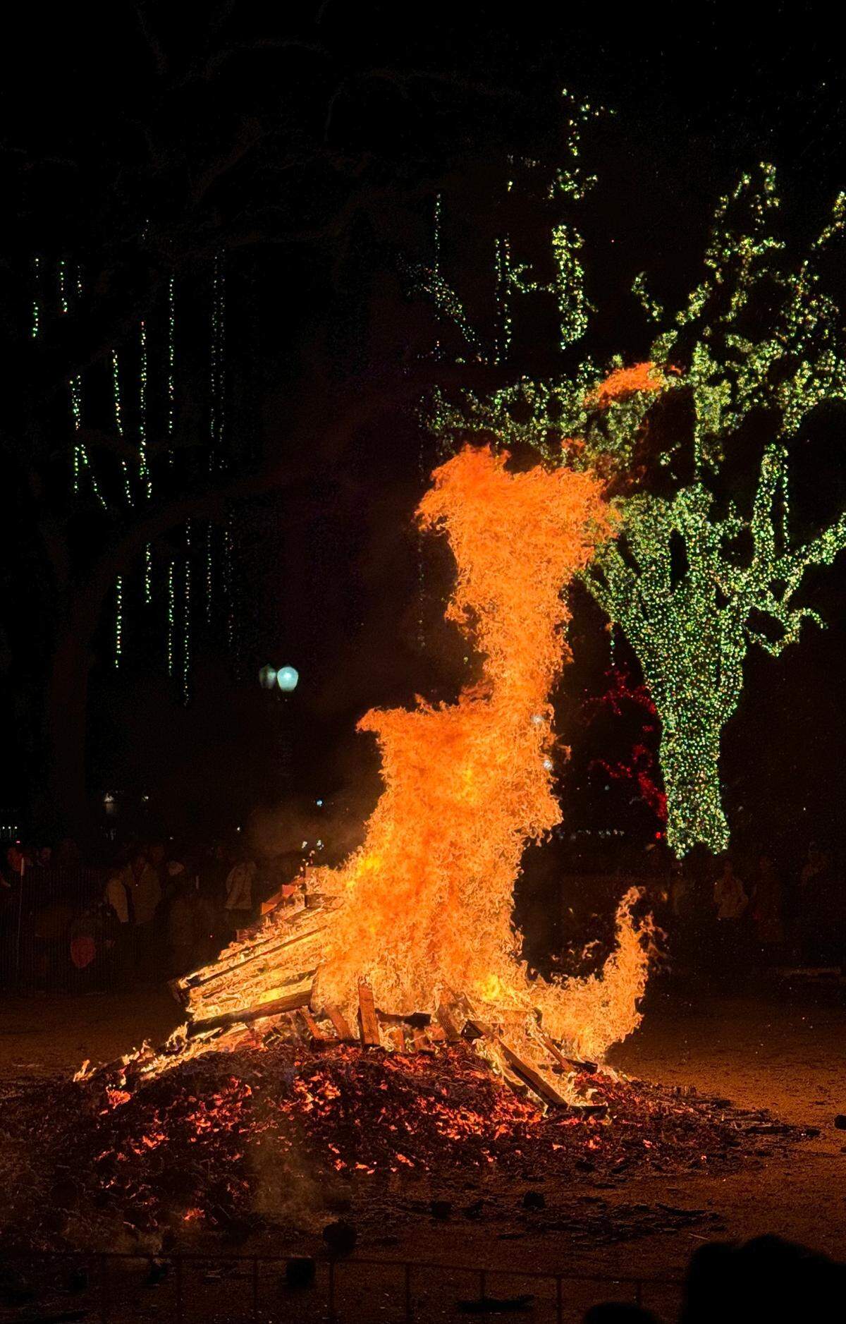 The giant bonfire throws flames into the air at Paso Robles’ New Year’s Eve celebration in the Downtown City Park on Dec. 31, 2023.