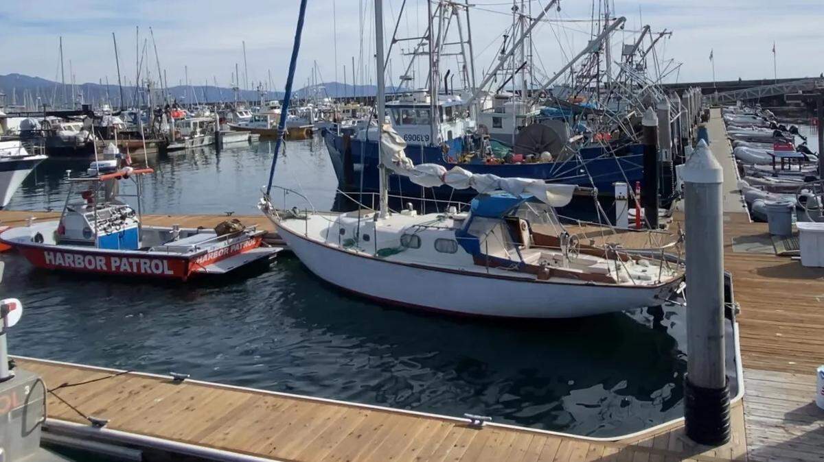 A towboat company discovered an adrift sailboat, right, on Sunday morning and Santa Barbara Harbor Patrol crews later found the body of a man in the water who is connected to the vessel.