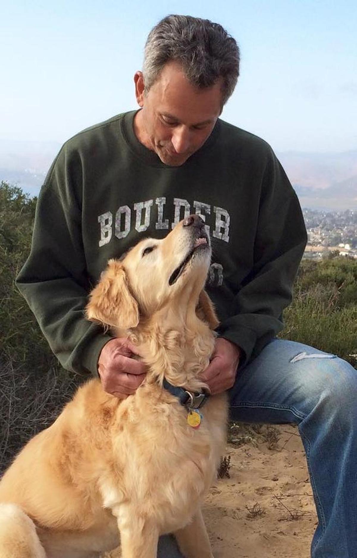 Toby, Morro Bay High School’s service dog, sits with his owner, teacher Daniel Freeman, during an after-school hike.