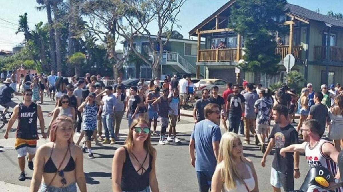 A mostly well-behaved crowd moves down Del Playa Drive in Isla Vista Saturday during ‘Deltopia,’ the community’s annual unsactioned street park marking the beginning of spring.
