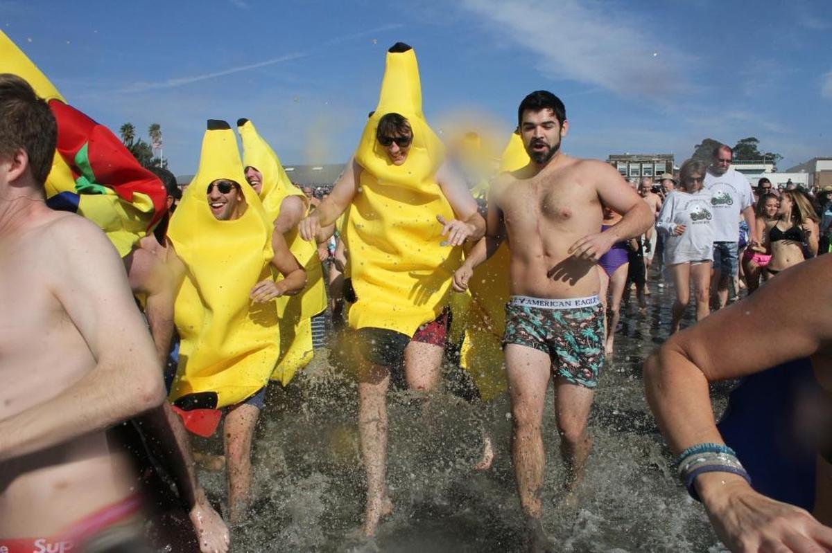 Participants in the Cayucos Polar Bear Dip dash into the sea on New Year’s Day.