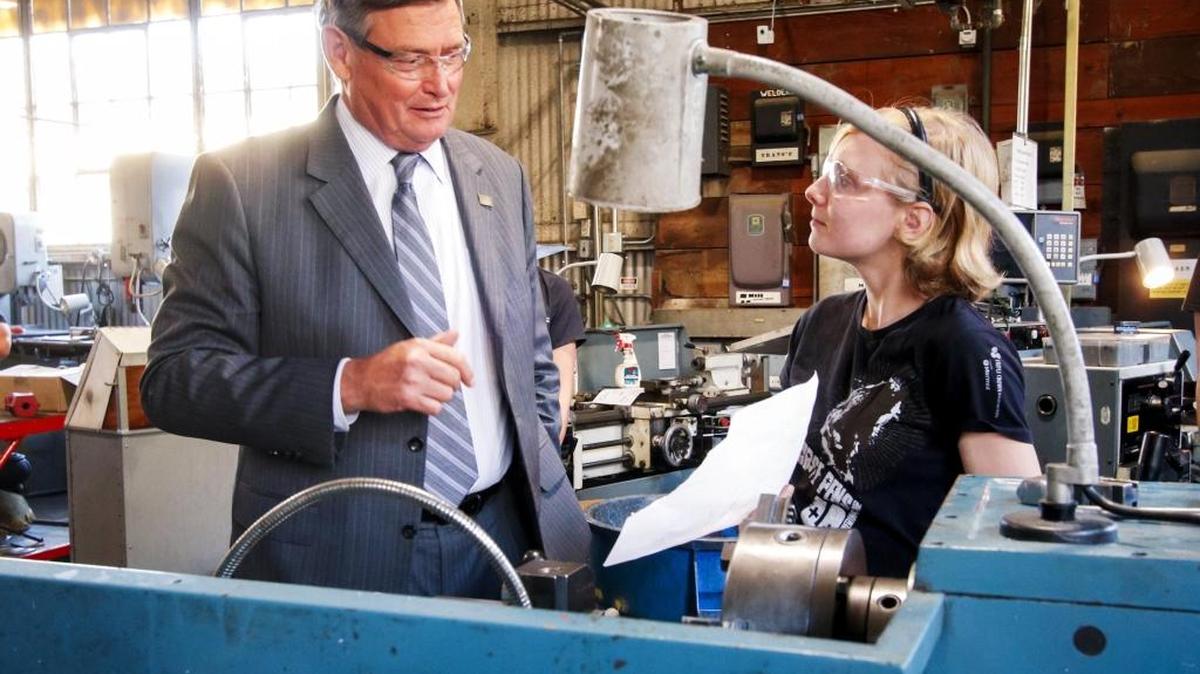 CSU Chancellor Timothy White, left, speaks with mechanical engineering junior Zoe Tuggle about working on a metal lathe during his visit to the Aero Hangar at Cal Poly as part of his visit to the campus where he met with students, faculty, staff, administration and alumni throughout the day. The visit was an opportunity for the chancellor to share his vision for the CSU moving forward and hear campus-specific input from the Cal Poly community.