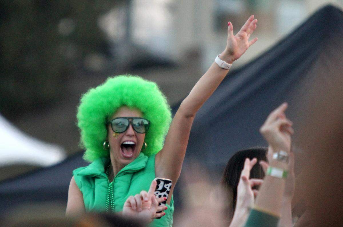 A concert-goer decked out in green yells along with the crowd as Galantis performs at Cal Poly’s “Morning on the Green” music festival on March 15, 2025. The event was an alternative to the St. Fratty’s Day street party.