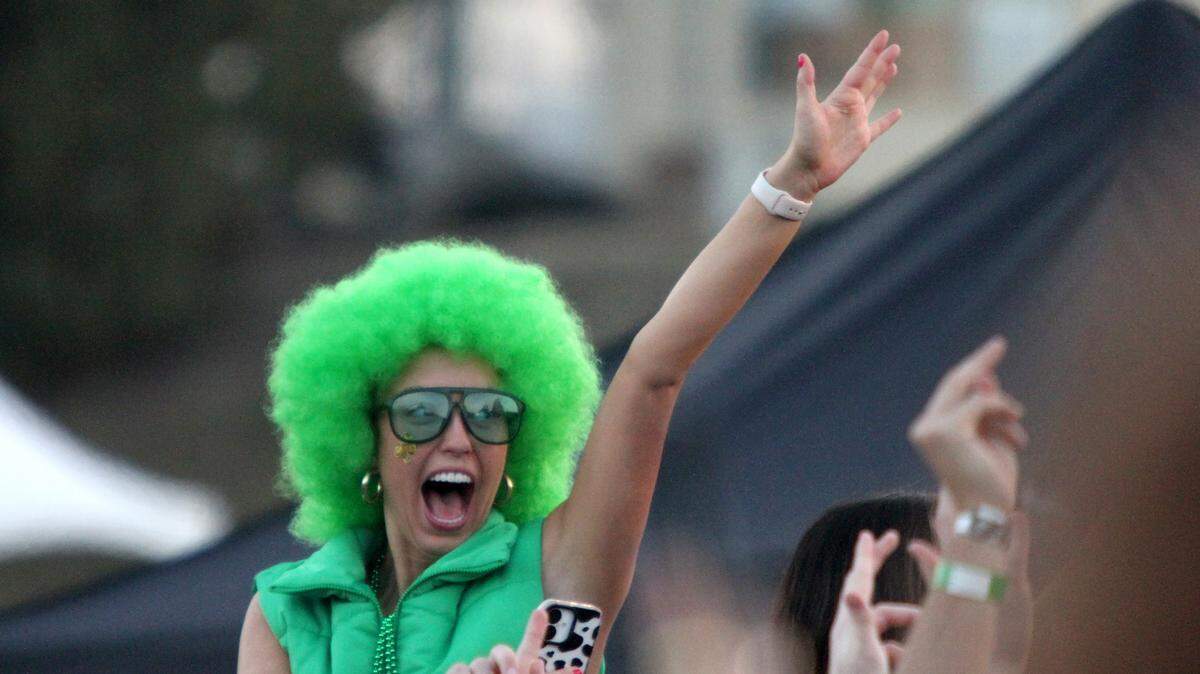 A concert-goer decked out in green yells along with the crowd as Galantis performs at Cal Poly’s “Morning on the Green” music festival on March 15, 2025. The event was an alternative to the St. Fratty’s Day street party.