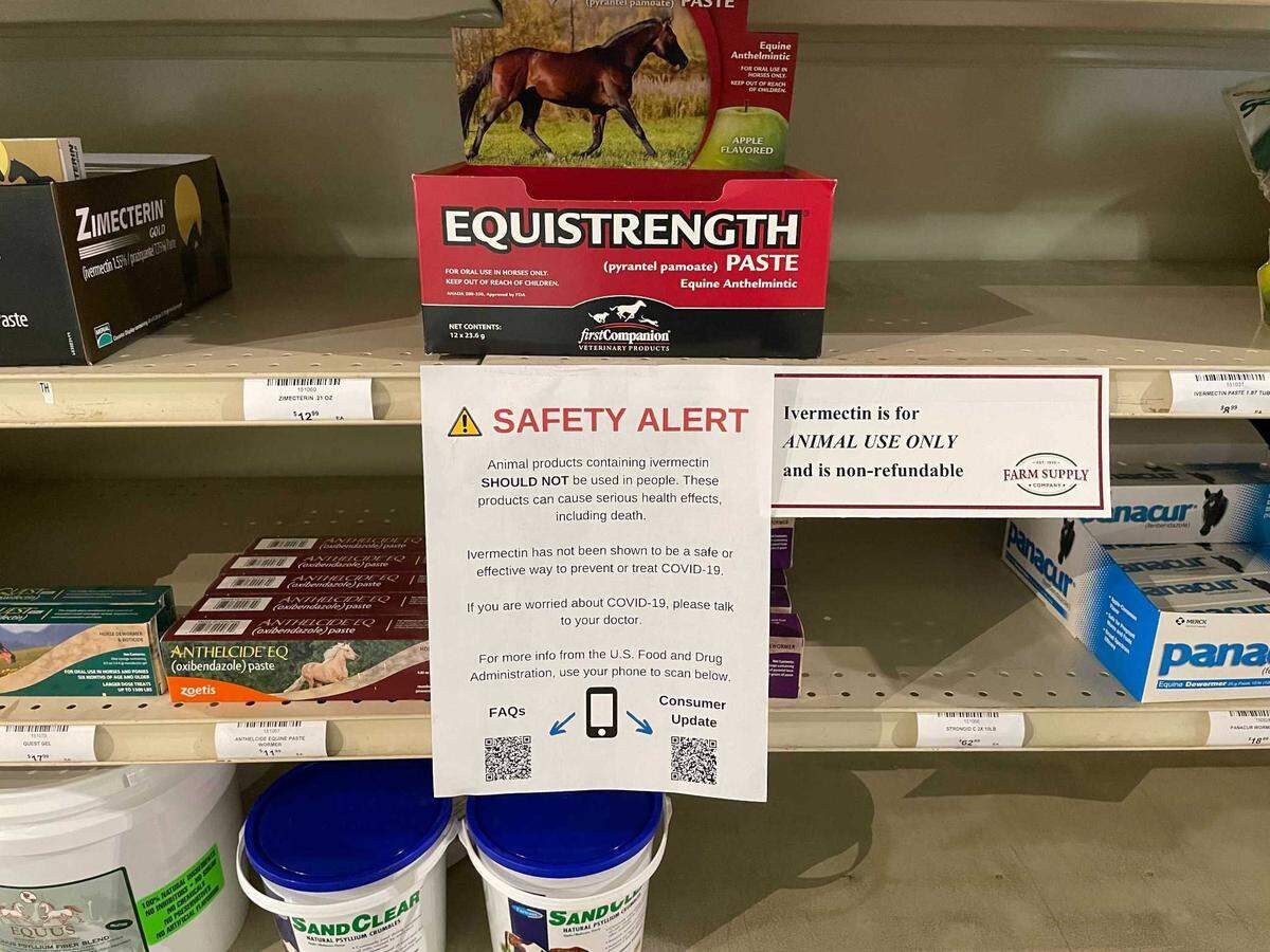 Signs warning against human use of ivermectin products intended for animals hang on shelves containing horse dewormers at Farm Supply in San Luis Obispo. A human version of the drug is used to kill parasites, but some people have been using it as a treatment for COVID-19. The FDA has said ivermectin should not be used for this purpose, and a prescription is required. To get around restrictions on the human version, some people have been purchasing ivermectin formulated for horses and livestock.