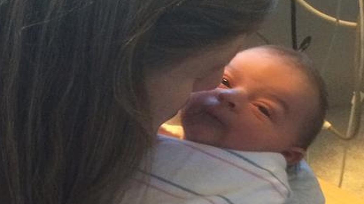 Aiden Christopher Webb, the first baby born in San Luis Obispo County in 2016, is held by his grandmother, Carrie Delos Santos.