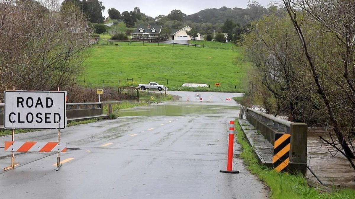 After a night of heavy rain, San Luis Obispo Creek floods San Luis Bay Drive on Saturday.