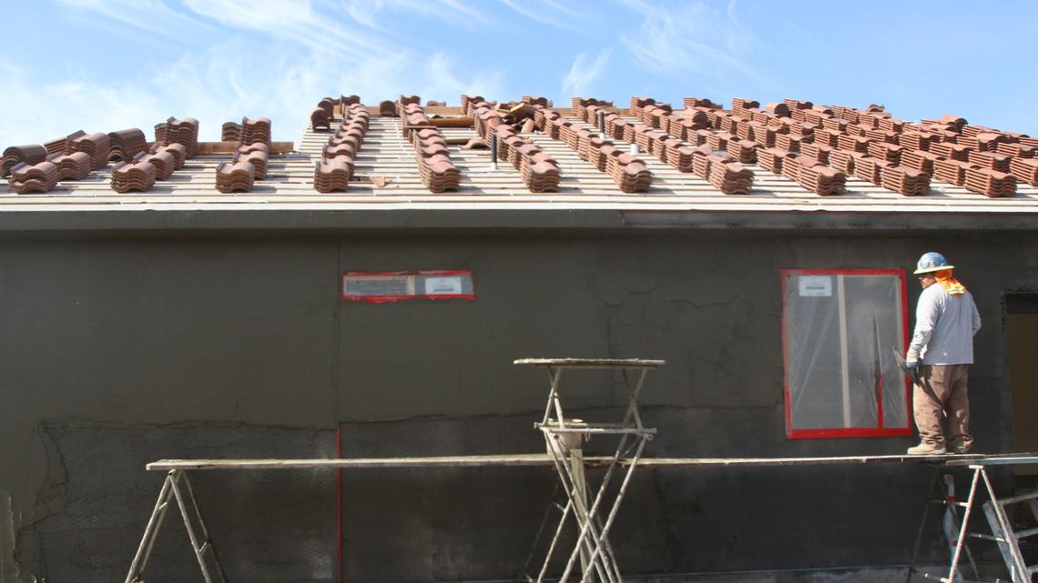 Sebastian Anguino stuccos a house at Montage at Serra Meadows where 31 new homes are being built on Prado Rd.