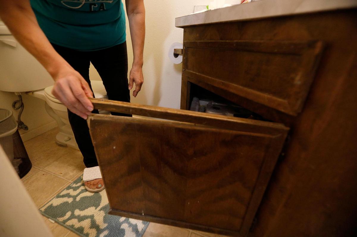 The cabinet door in Blanca’s Oceano bathroom is coming apart at the top, making it difficult to open.