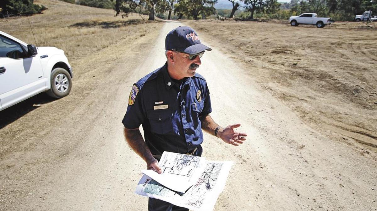 Cal Fire/San Luis Obispo Chief Rob Lewin talks about critical moments of the Cuesta Fire as he stands on the road where fire crews stopped the fire’s advance about a quarter mile from Santa Margarita in August.