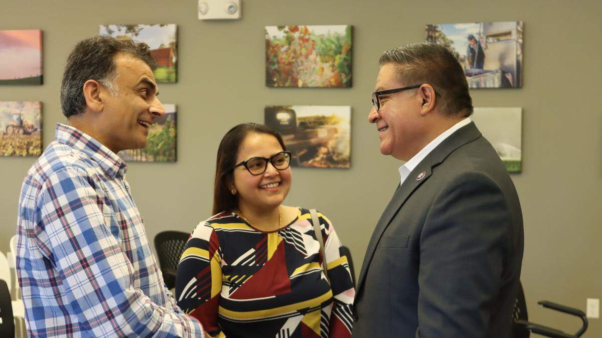 Rep. Salud Carbajal greets the owners of the Los Padres Inn at a town hall in San Luis Obispo on Thursday, Aug. 17, 2023.