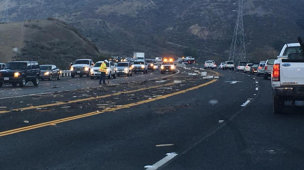 Traffic on the Cuesta Grade is slow Thursday morning after bee boxes fell off a truck and debris scattered through the lanes.