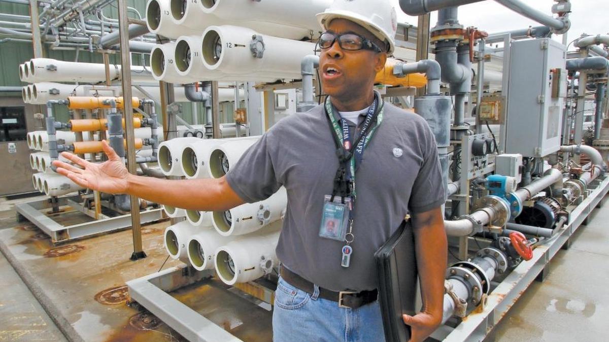 Terence East, field area manager with General Electric, shows visitors the reverse osmosis unit that supplies desalinated seawater at Diablo Canyon nuclear power plant during a 2015 tour.