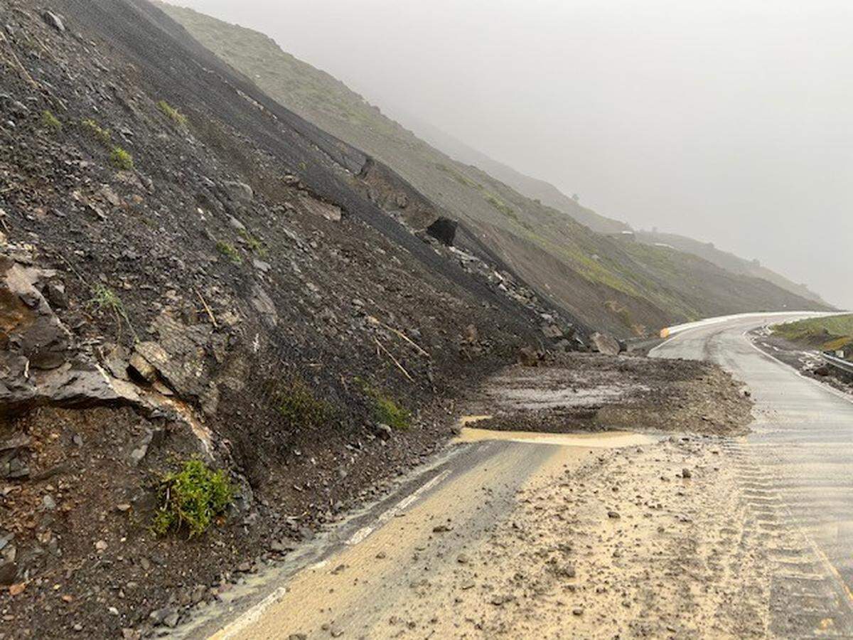 A landslide at the north end of Mud Creek is one of several blocking Highway 1. A boulder the size of shipping container is resting precariously on slide material above the roadway. Mud Creek is the location of a massive slide in 2017 that took more than a year of work and $54 million to repair.