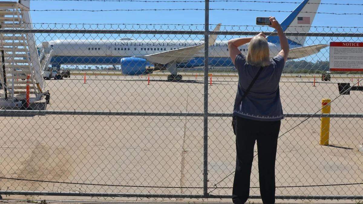 Julie Michealsen takes a picture of Air Force One at the Santa Barbara Airport Tuesday morning. President Joe Biden and his family are vacationing in the Santa Ynez Valley.