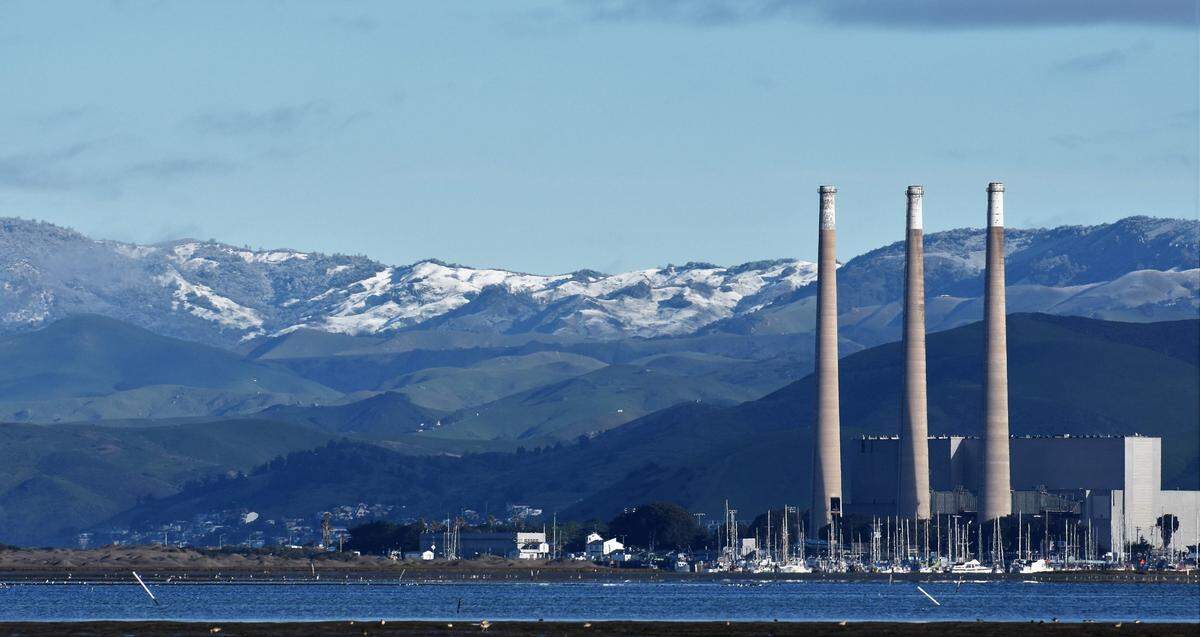 Snow adorns the hills behind Morro Bay on Thursday morning, Feb. 23, 2023.