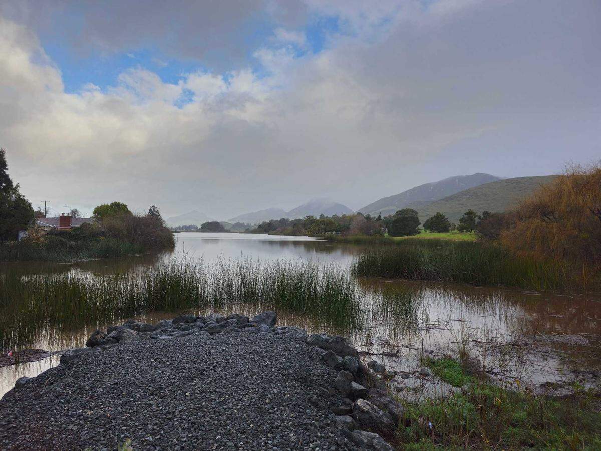 Laguna Lake rose well above its usual elevation during a storm, and spilled out underneath Madonna Road, on Feb. 19, 2024. The overspill also fed to the area below the Froom Ranch Road bridge near Dick’s Sporting Goods, creating a fast-moving creek.