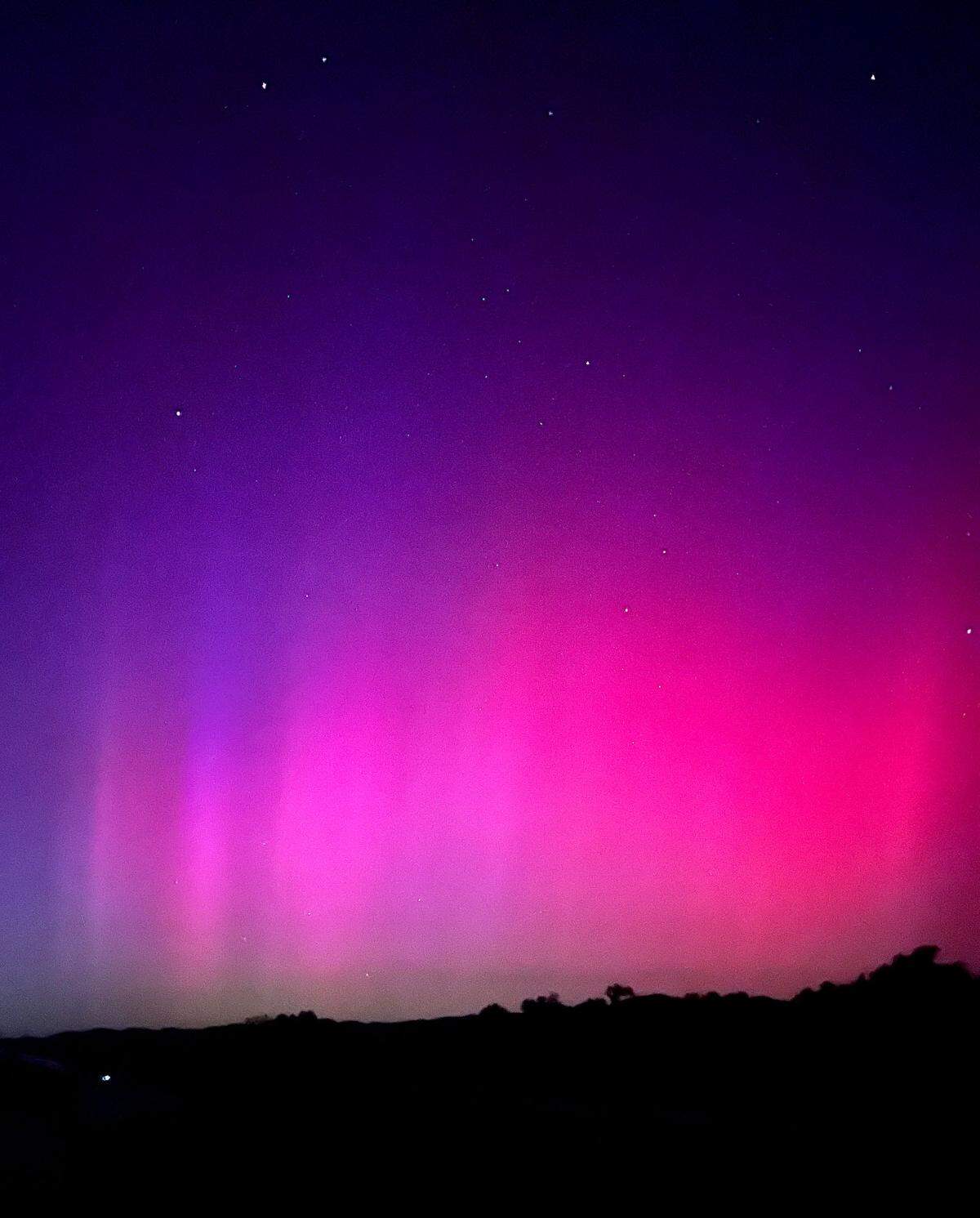 The northern lights illuminate the skies over Santa Margarita in pinks and purples on May 10, 2024.