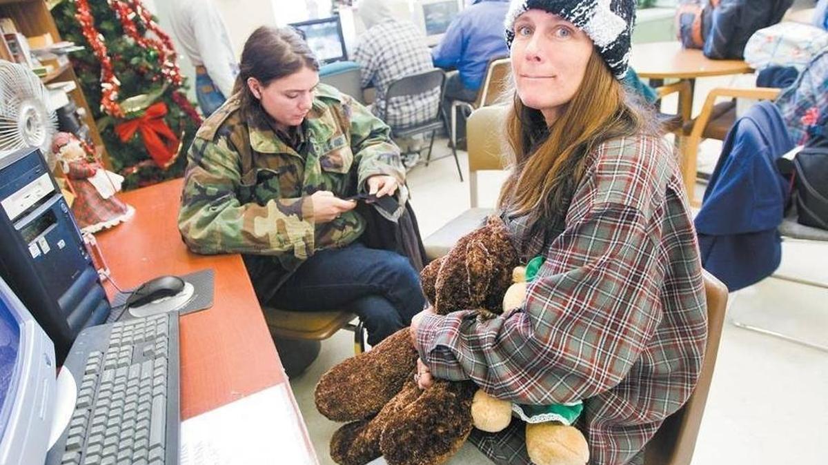 Reginia Orton, right, and her daughter Marlena use the facilities at the Prado Day Center on the afternoon of Christmas Eve. The center opens a warming station in this common area for especially cold or wet nights, including this weekend through Monday.