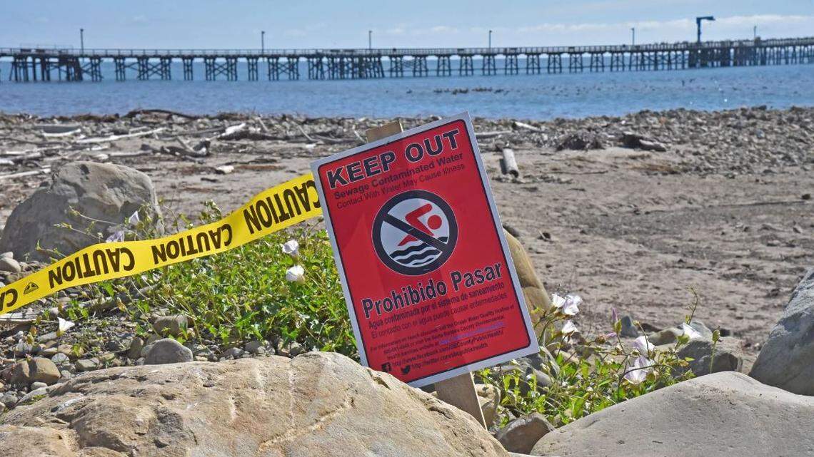 A sign at Goleta Beach Park warns people to stay out of the water due to a recent major raw sewage spill
