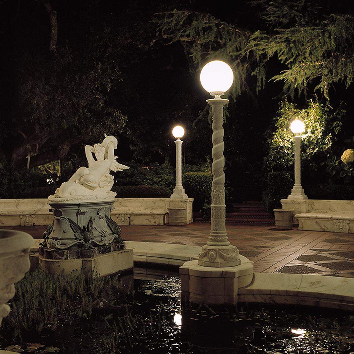 “Galatea on a Dolphin,” a 19th Century Italian marble sculpture, is illuminated in the Lily Pond on the Main Terrace of Hearst Castle. It’s one of the many works that can be viewed as part of the “Art Under the Moonlight” tour.