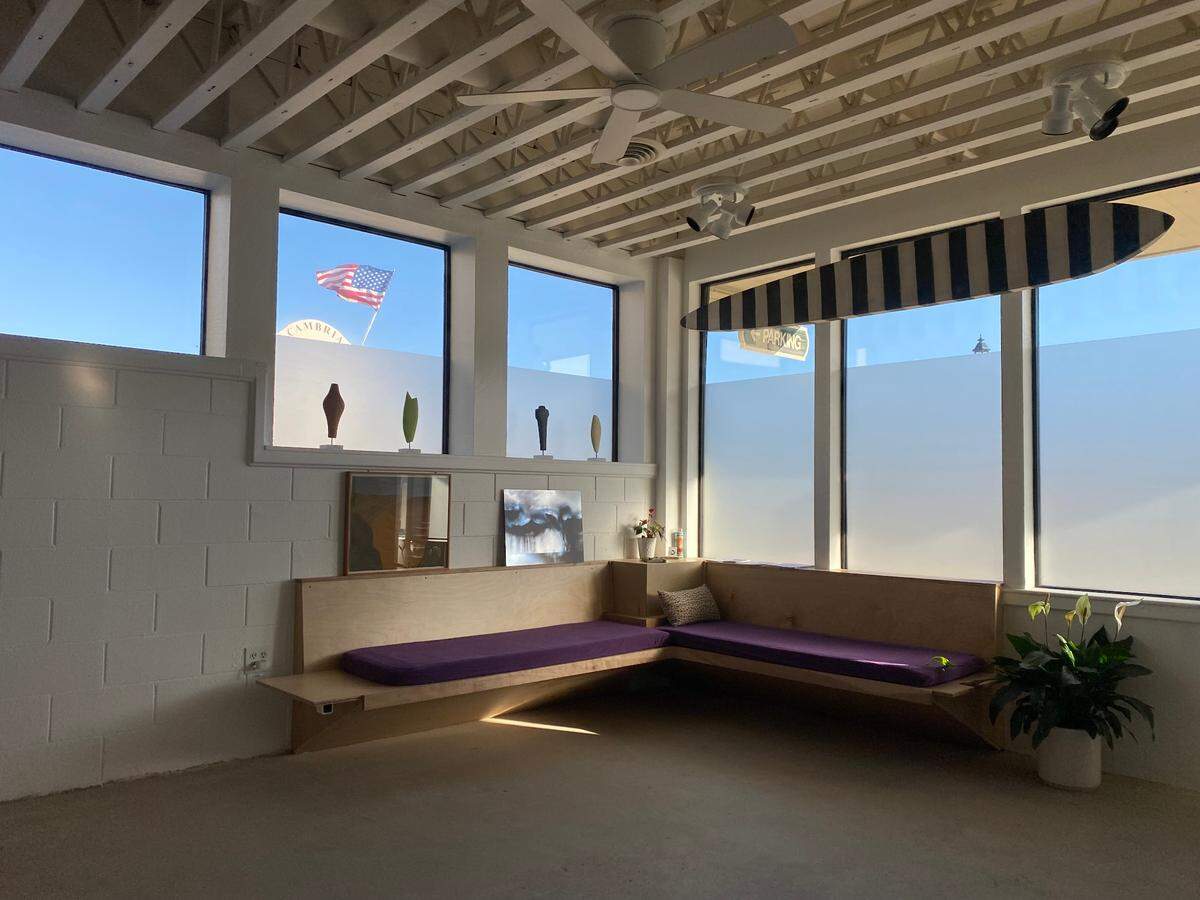 The benches in this corner at Cambria’s new Cruise Control Gallery help visitors relax and chill out while chatting with shop owner Charlie Smith and learning about the artworks on display. Smith had the lower portion of the windows etched to block out views of busy Main Street.