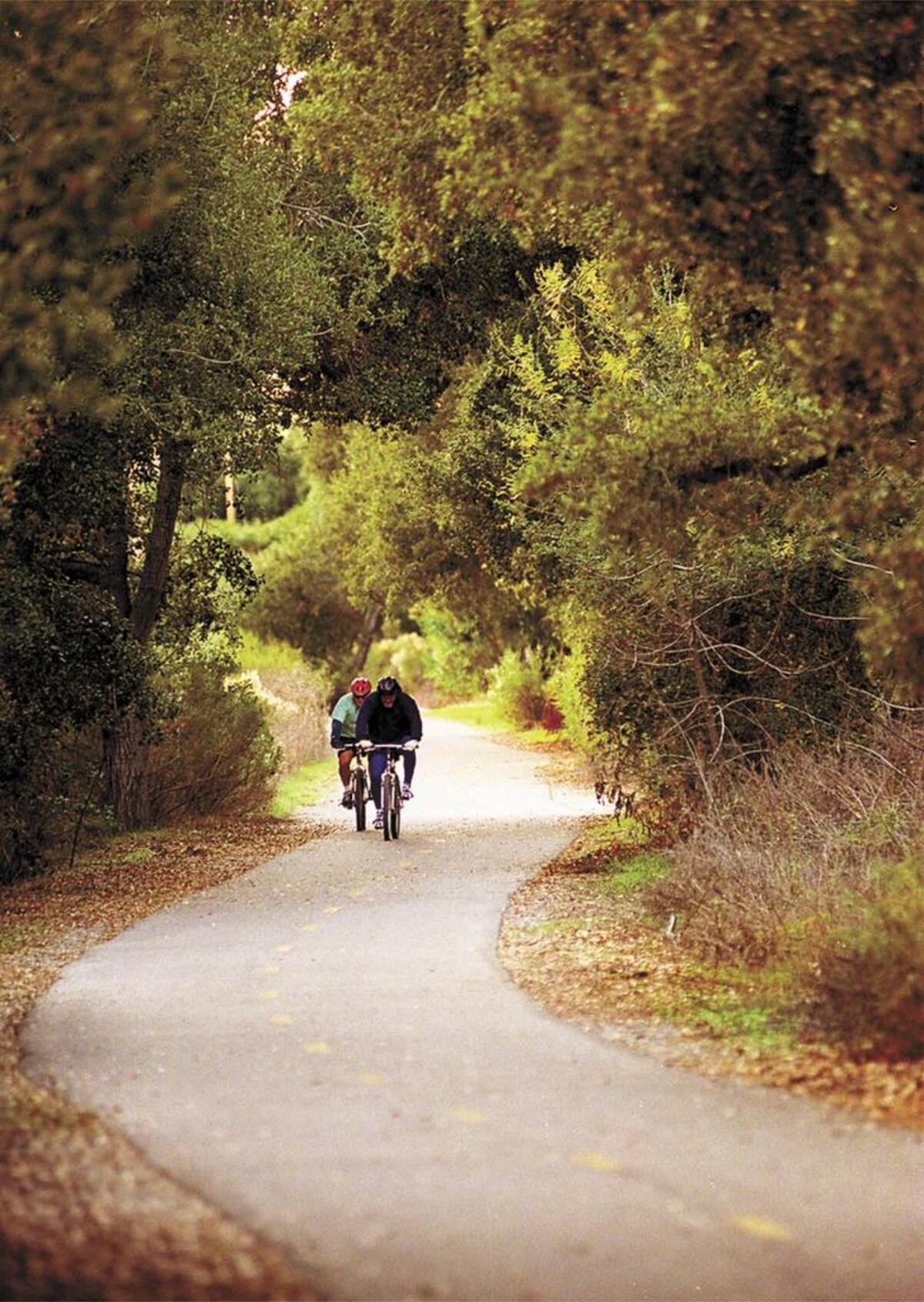 Bicyclists ride along part of the Bob Jones trail in Avila Beach.