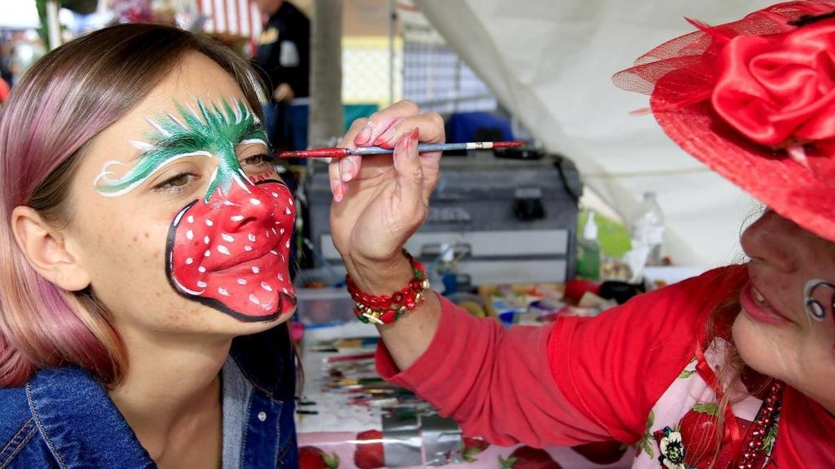 “Painter of Faces” Teresa Schmidt, based in Grover Beach, paints a large strawberry on Lava Farmer of Nipomo during the 33rd Arroyo Grande Strawberry Festival on Sunday, May 29, 2016.